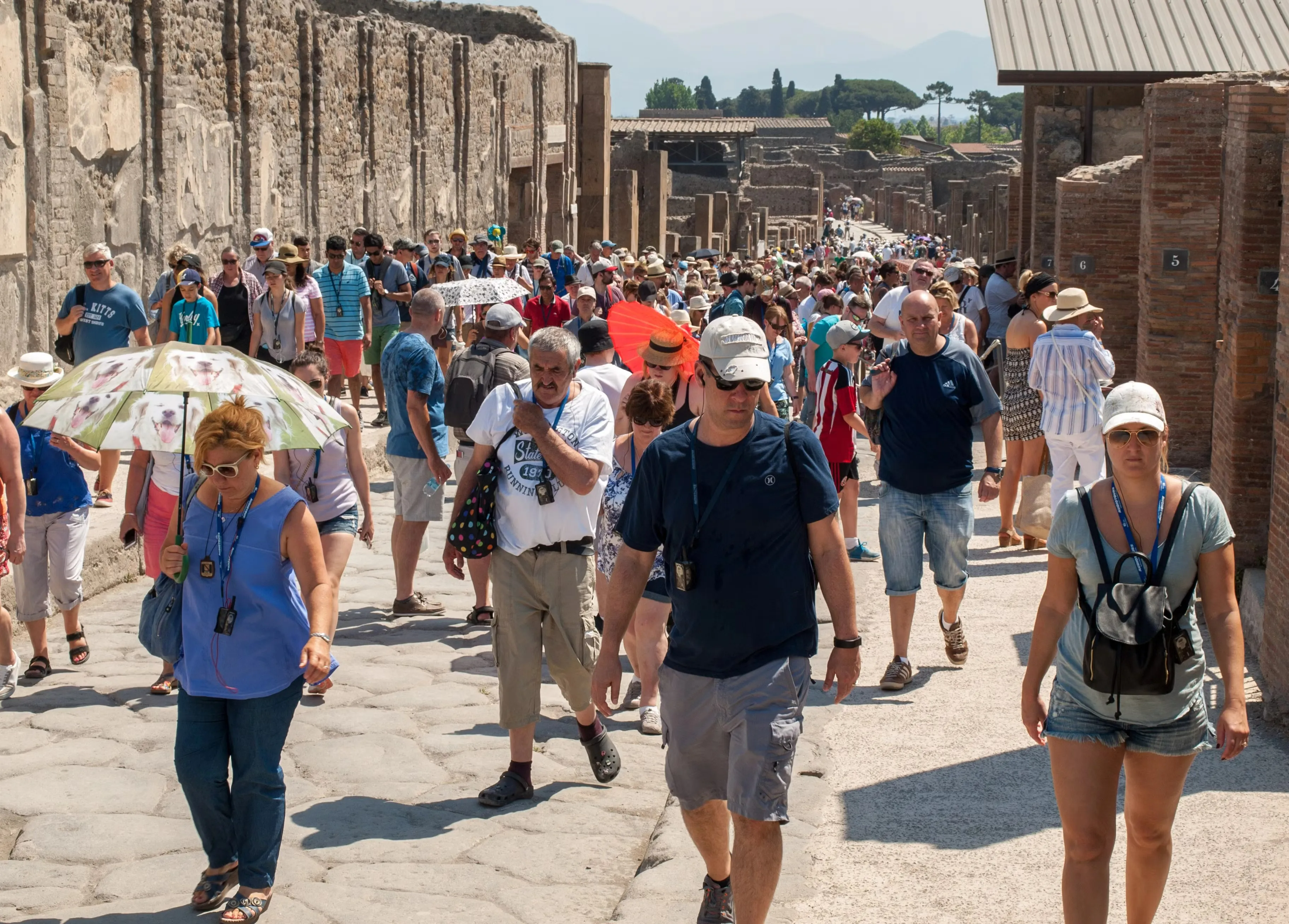 Tourists walking through the UNESCO World Heritage archaeological site of Pompeii
